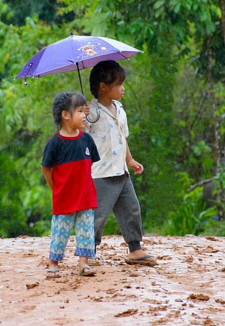 Fillettes sous la pluie au Laos.